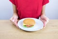 Closeup on plate with sandwich in hand Royalty Free Stock Photo