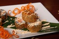 Closeup of a plate of tempura Maki with cheese, onions, and salmon