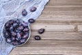 Closeup of plums in a bowl on wooden background. Top view. Royalty Free Stock Photo