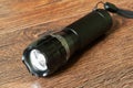 Closeup pocket LED flashlight on dark background Royalty Free Stock Photo