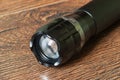 Closeup pocket LED flashlight on dark background Royalty Free Stock Photo