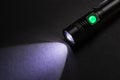 Closeup pocket LED flashlight on dark background Royalty Free Stock Photo