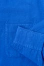 Closeup pocket and sleeve of blue fabric shirt