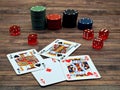 Closeup of poker cards, poker chips and dice on a wooden table Royalty Free Stock Photo