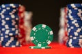 Closeup of poker chips on red felt card table surface Royalty Free Stock Photo