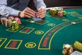 Closeup of poker player with playing cards and chips Royalty Free Stock Photo