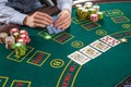 Closeup of poker player with playing cards and chips Royalty Free Stock Photo