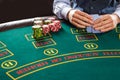 Closeup of poker player with playing cards and chips Royalty Free Stock Photo