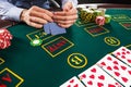 Closeup of poker player with playing cards and chips Royalty Free Stock Photo