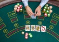 Closeup of poker player with playing cards and chips Royalty Free Stock Photo