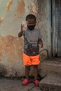Closeup of a poor Cuban boy toasting a glass of water Royalty Free Stock Photo