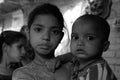 Closeup of a poor girl child with a baby