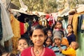 Closeup of a poor girl with a group slum india