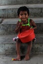 Closeup of a poor staring hungry orphan boy in a refugee camp with sad expression.