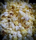 Closeup of popcorns with melted butter isolated from black round vignettes, food photography, snacks background