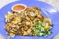 Closeup on popular Penang fried oyster omelette egg served with chilli dip Royalty Free Stock Photo