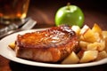 closeup of pork chop with shiny apple sauce glaze