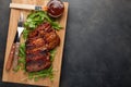 Closeup of pork ribs grilled with BBQ sauce and caramelized in honey on a bed of arugula. Tasty snack to beer on a Royalty Free Stock Photo