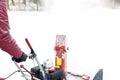 Man using red snowblower machine outdoor. Removing snow near house from yard