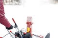 Man using red snowblower machine outdoor. Removing snow near house from yard Royalty Free Stock Photo