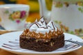 Closeup of a portion of delicious brownie with manjar and meringue on a white plate