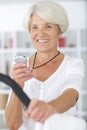 Closeup portrait active senior woman checking stop-watch Royalty Free Stock Photo