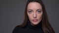 Closeup portrait of adult attractive caucasian female face looking at camera with background isolated on gray