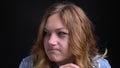 Closeup portrait of adult caucasian female putting a finger to her lips calling for being quiet with background isolated