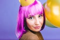 Closeup portrait amazing joyful young woman with cut purple hair, golden crown and balloons celebrating carnival, new