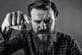 Closeup portrait of an angry bearded man threatening with his fist Royalty Free Stock Photo