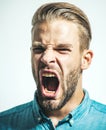 Closeup portrait of angry displeased man screaming. Furious man with mouth opened in shout. Stress and negative emotions Royalty Free Stock Photo