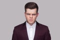 Closeup portrait of angry handsome young man in violet suit and Royalty Free Stock Photo