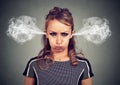 Closeup portrait of angry young woman, blowing steam coming out of ears Royalty Free Stock Photo