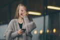 Closeup portrait anxious young girl looking at phone seeing bad news, photos with disgusting expression on face about to