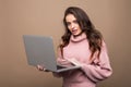 Closeup portrait of attractive caucasian smiling woman brunette isolated on brown studio shot lips toothy smile face hair head and Royalty Free Stock Photo