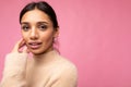 Closeup portrait of attractive cute nice adorable tender young brunette woman in casual beige sweater isolated on pink Royalty Free Stock Photo