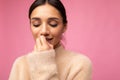 Closeup portrait of attractive cute nice adorable tender young brunette woman in casual beige sweater isolated on pink Royalty Free Stock Photo