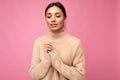 Closeup portrait of attractive cute nice adorable tender young brunette woman in casual beige sweater  on pink Royalty Free Stock Photo
