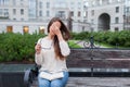 Closeup portrait of attractive female with eyeglasses in hand. Poor young girl has issues with vision. She rubs her nose and eyes Royalty Free Stock Photo