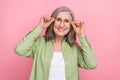 Closeup portrait of attractive grandmother trying her new perfect eyeglasses goggles ophthalmology shop isolated on pink