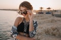 Closeup portrait of attractive young girl taking off stylish sunglasses, on sunset, on beach with sensual look. Wearing Royalty Free Stock Photo