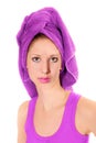 Closeup portrait of an attractive young woman with a towel on her head after washing her hair Royalty Free Stock Photo