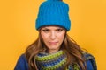 Closeup portrait of attractive young woman in warm sweater, hat and scarf. Autumn-winter clothing. Smiling girl in Royalty Free Stock Photo