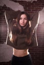 Closeup portrait of awesome brunette woman wears oversize sweater, posing on a brick wall background