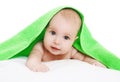 Closeup portrait of baby lying under green towel Royalty Free Stock Photo