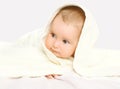 Closeup portrait of baby under towel on the bed Royalty Free Stock Photo