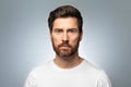 Closeup portrait of bearded handsome caucasian middle aged man looking at camera, posing isolated over grey background Royalty Free Stock Photo