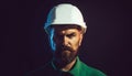 Closeup portrait of bearded man in protective helmet. Serious mechanical worker, foreman or repairman in construction Royalty Free Stock Photo