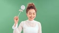 Closeup portrait of beautiful fashion cheerful woman eating sweet candy lolly pop over green background Royalty Free Stock Photo