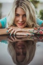 Closeup portrait of. Beautiful girl put her head in her arms with tattoos. expectation. Royalty Free Stock Photo